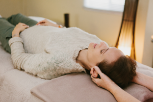 Lady receiving relaxing Craniosacral Therapy